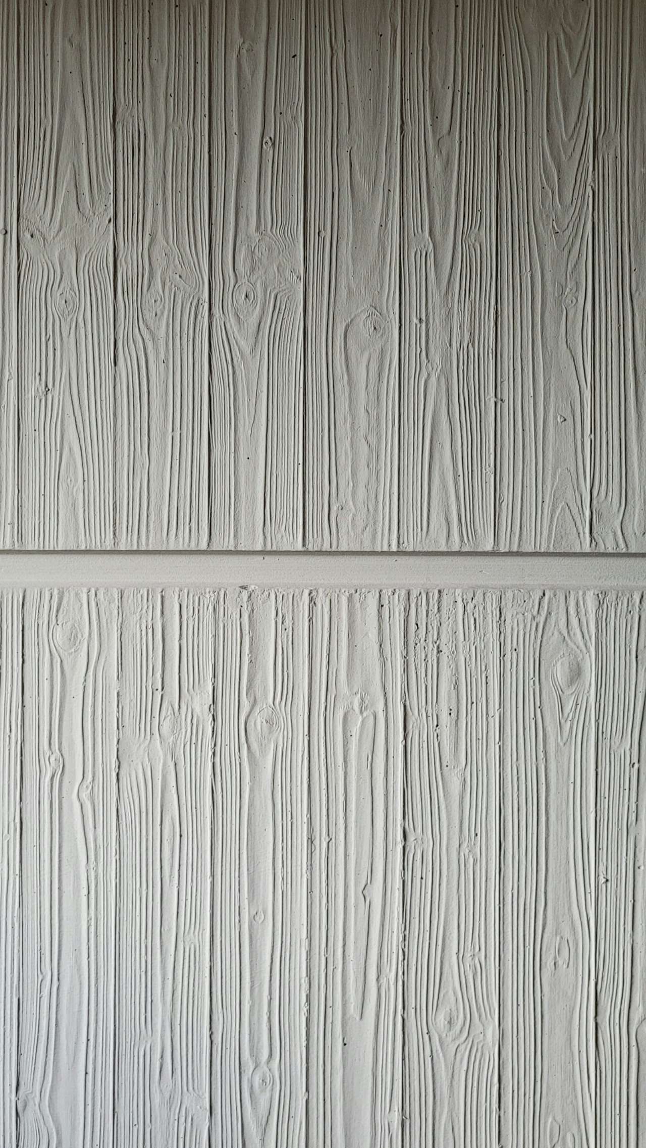 Close-up of painted lap siding boards with an embossed woodgrain texture