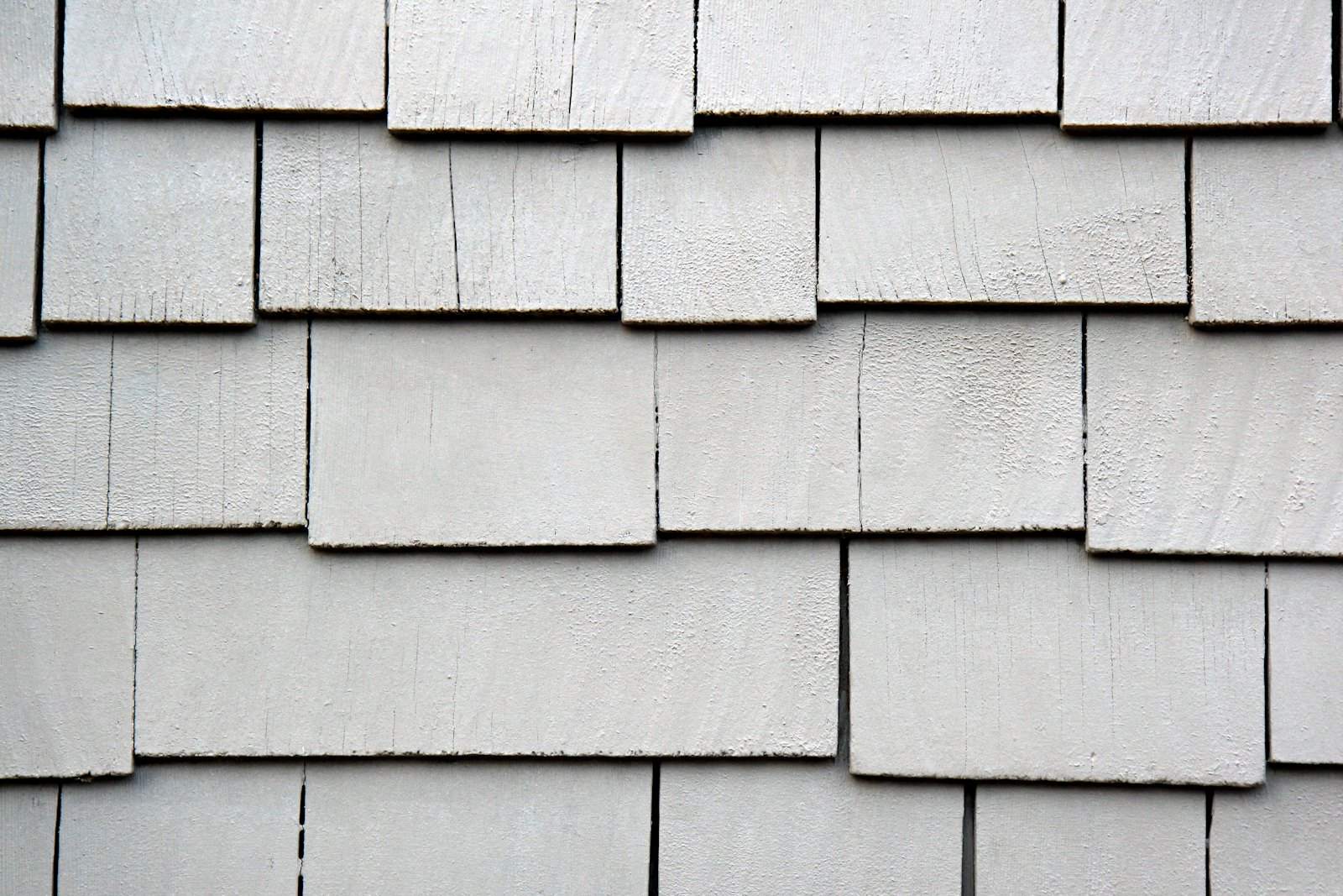 Close-up of gray painted shingle siding