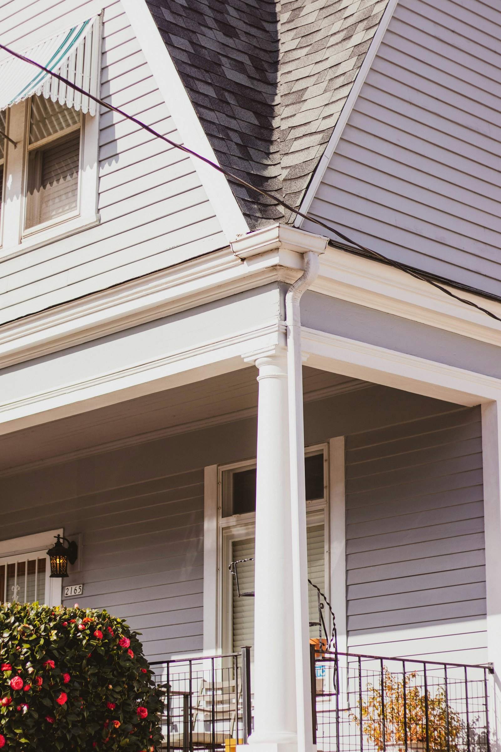 Porch column and soffit on a house with lavender-gray siding
