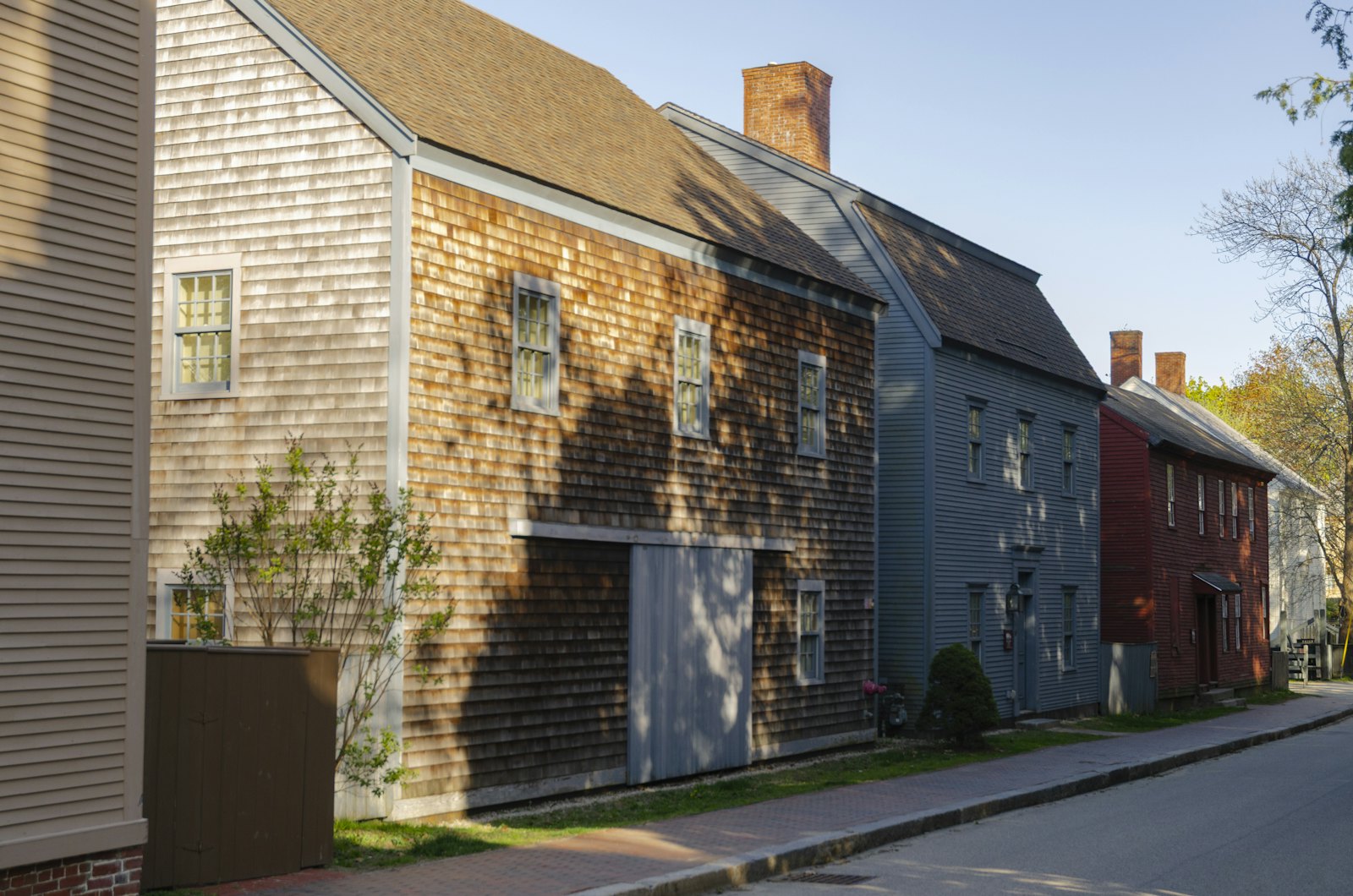Row of historic houses with weathered gray wood shingles